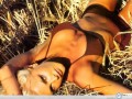 Caprice Bourret lying in country wallpaper