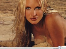 Caprice Bourret lying in the sand wallpaper