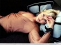 Charlize Theron wallpapers: Charlize Theron lying on pillows wallpaper