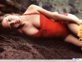 Josie Maran wallpapers: Josie Maran sexy in red on sand wallpaper